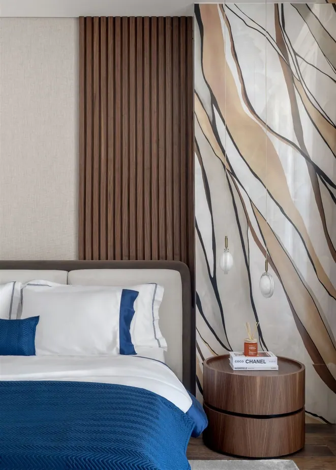 Bedroom with a walnut slat panel, hand-painted wallcovering and a round walnut bedside table