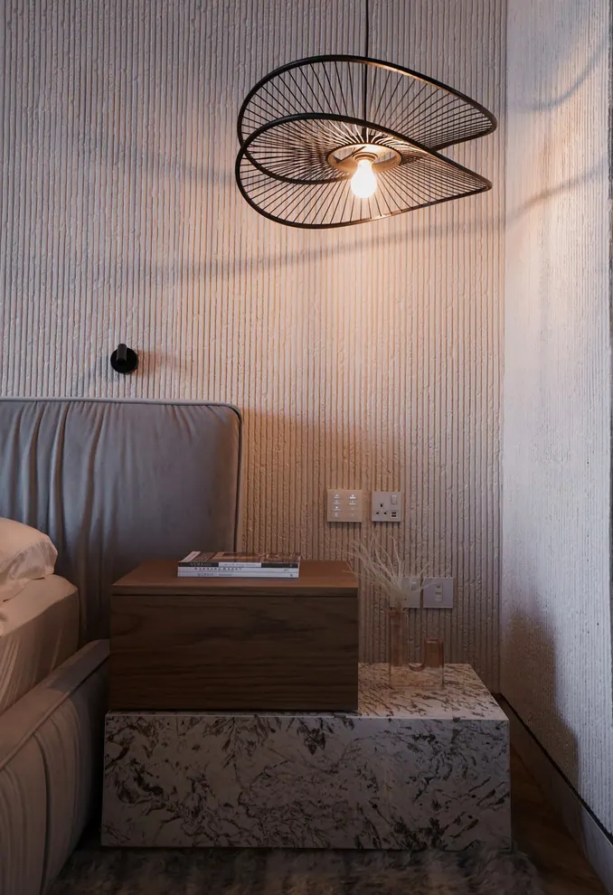 Bedside with a wire pendant lamp, combed plaster wall and a walnut and marble bedside table