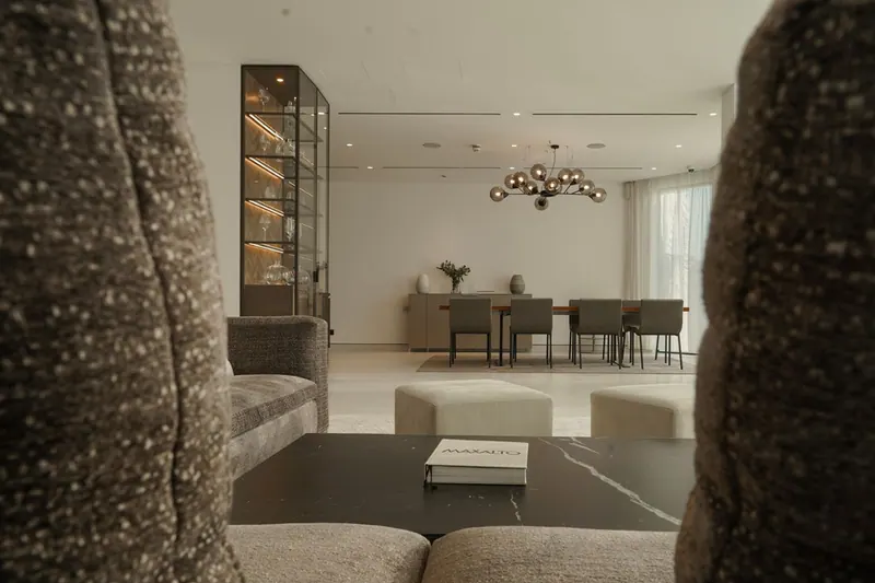 View from the sofa to the dining area with a smoked glass chandelier and the display cabinet
