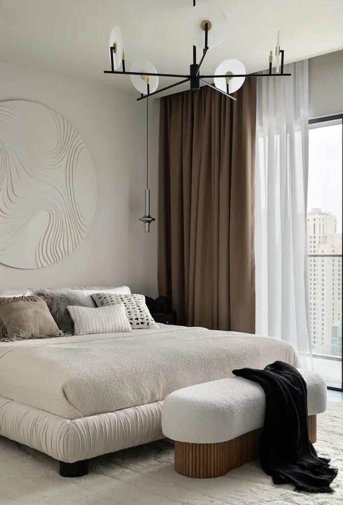 Bedroom with a plaster relief roundel, ruched upholstered bed and cocoa curtains