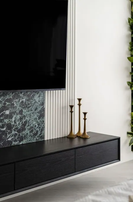 TV wall with a green marble inset and a floating black oak unit